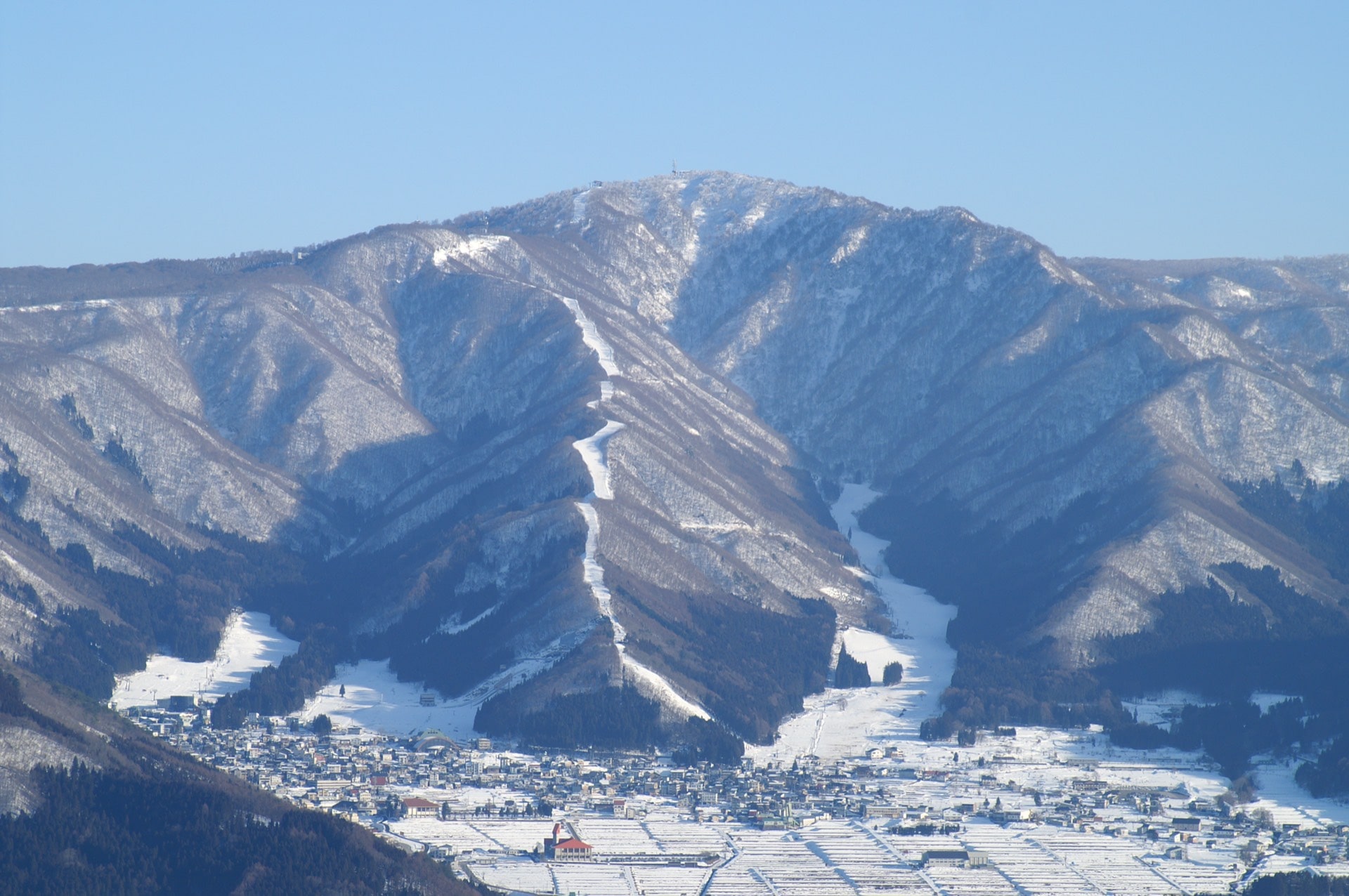 Nozawa Onsen village in Nagano under snow-covered ski slopes